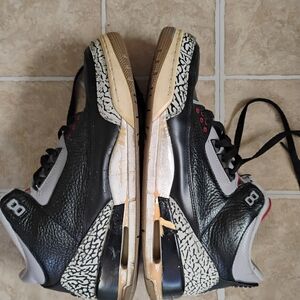 Black and Gray Sneakers with Red Accents